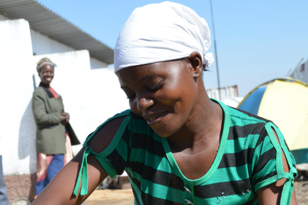 Rosalina, African woman, making baskets