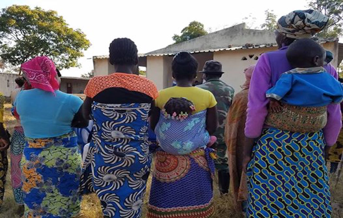 African women walking with babies on their backs, rear view