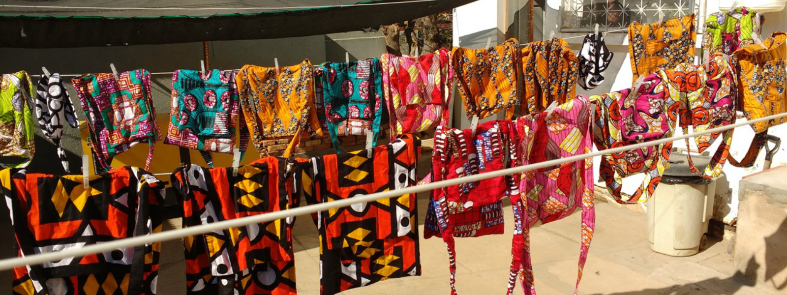 Clotheslines with colorful handmade bags, Hope for Our Sisters