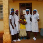 Five African nurses with very young woman and newborn child