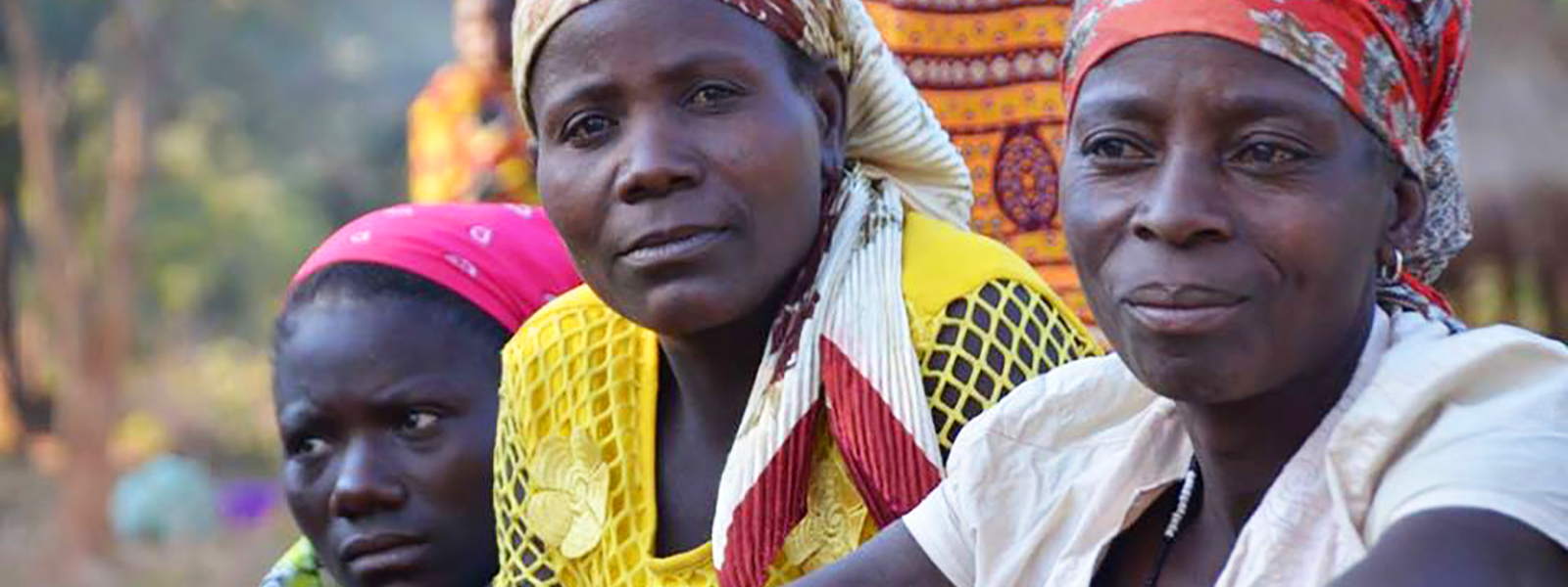 Three African women listening to information on fistula prevention