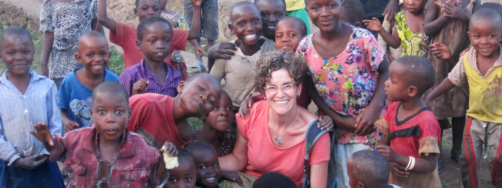 Founder Brooke Sulahian surrounded by local children in Angola