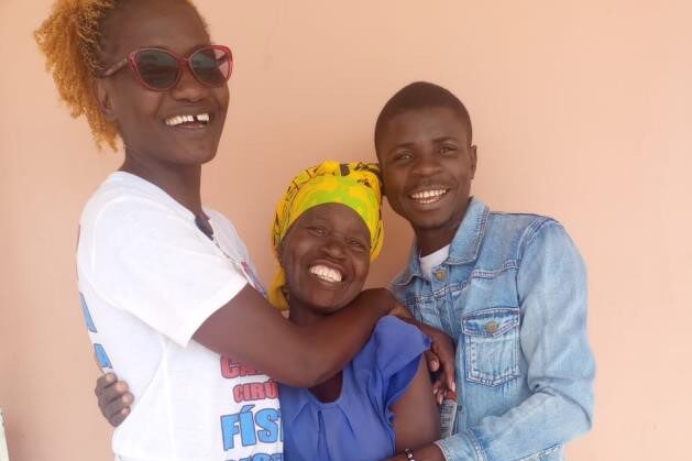 Votoka trauma counselors embracing a smiling patient