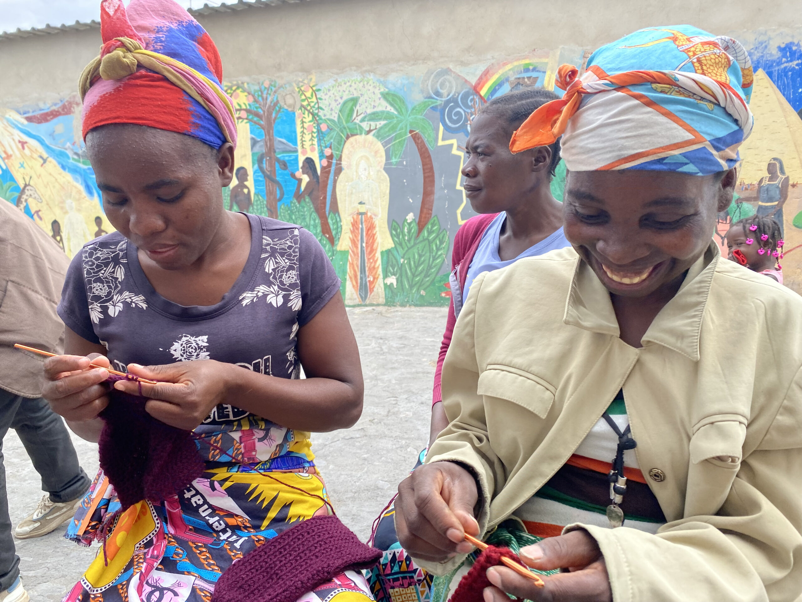 Two Angolan women crocheting