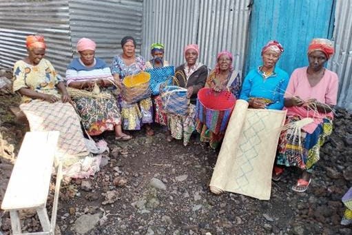 Congolese women displaying their hand-woven baskets and mats